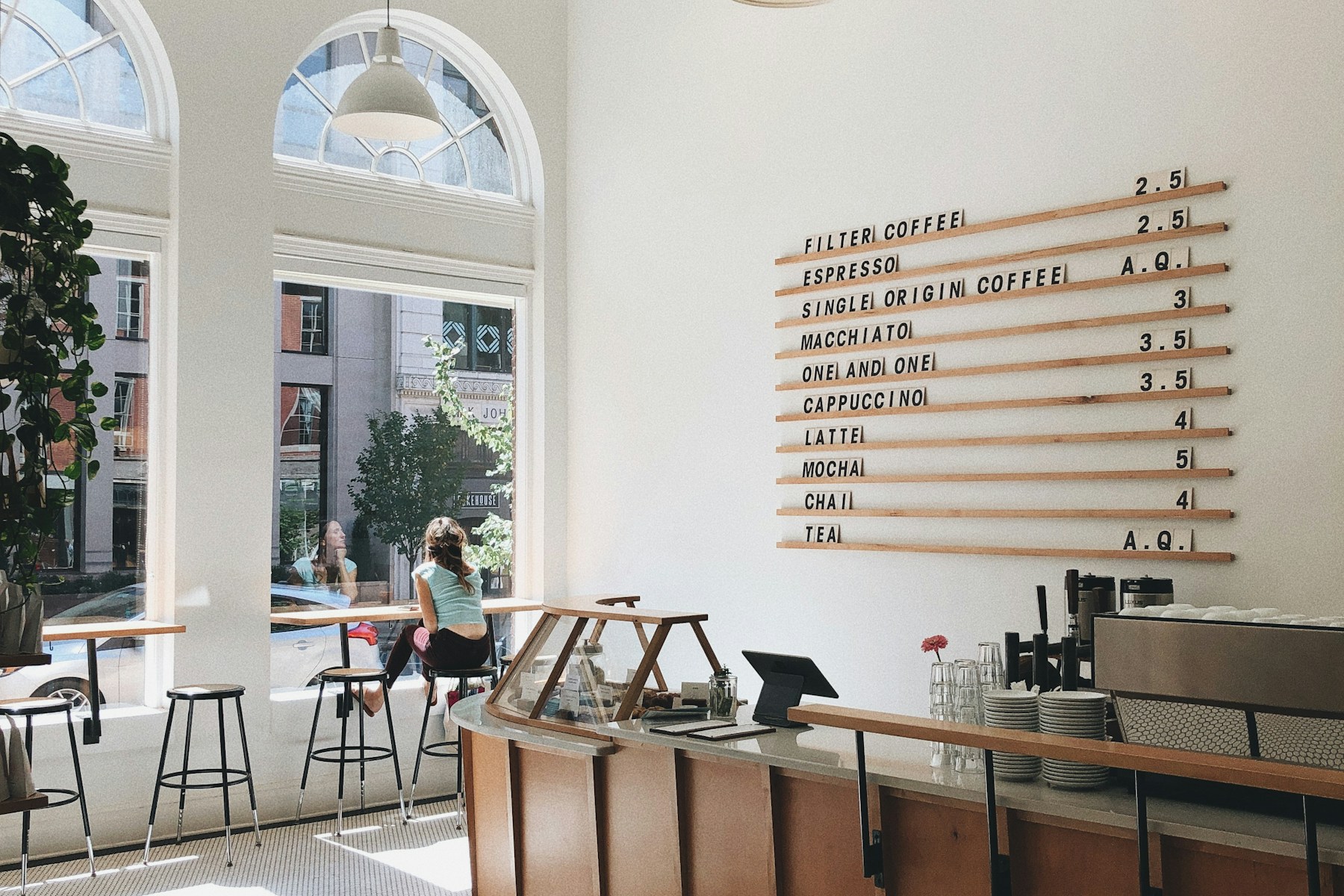 Bright café with a curved counter and coffee equipment